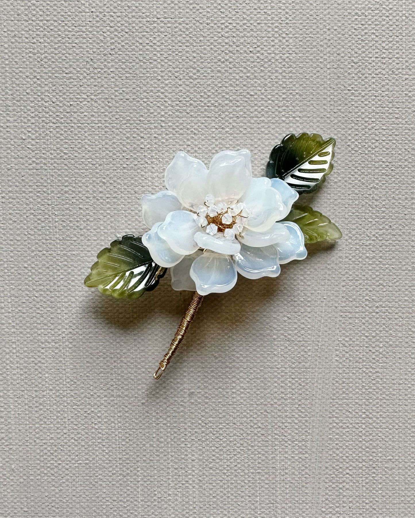 The new peony lapel brooch in milk glass