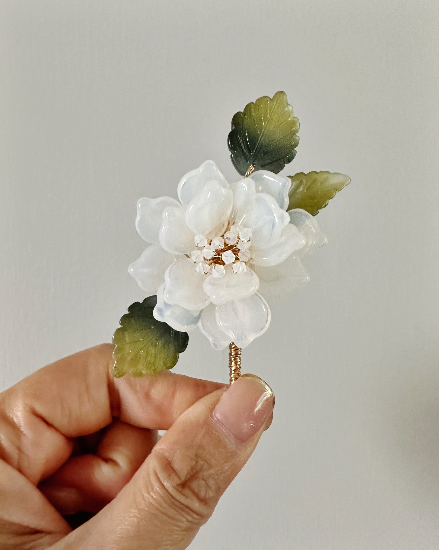 The new peony lapel brooch in milk glass