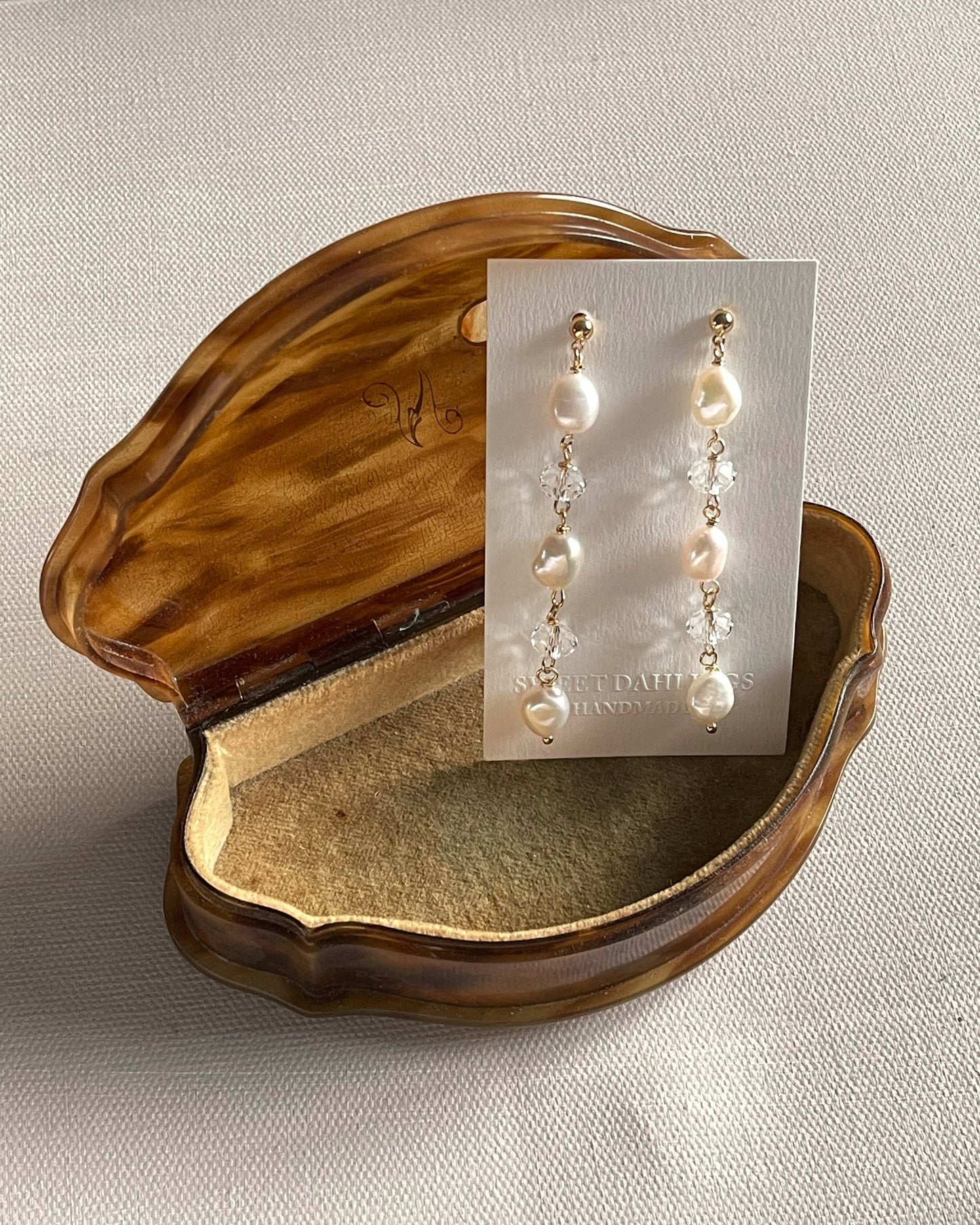 The chandelier earrings in white freshwater pearls