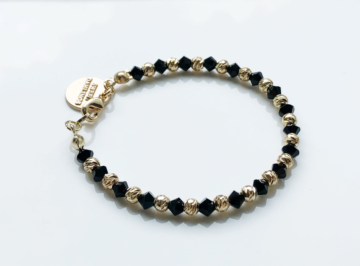 Swarovski crystal and 14K gold plated beads bracelet in black and gold