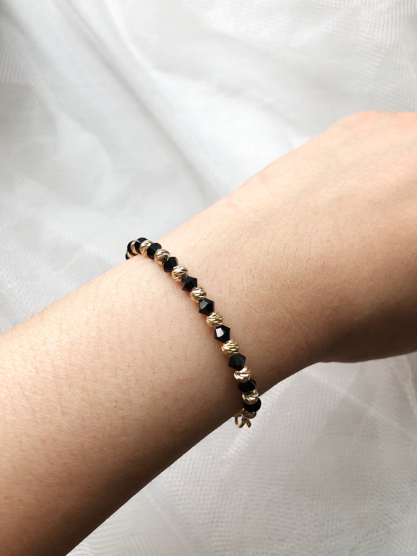 Swarovski crystal and 14K gold plated beads bracelet in black and gold