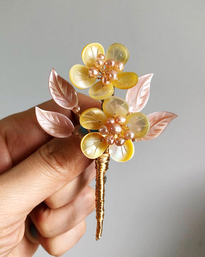 A mother’s embrace shell and freshwater pearl brooch (yellow and white)