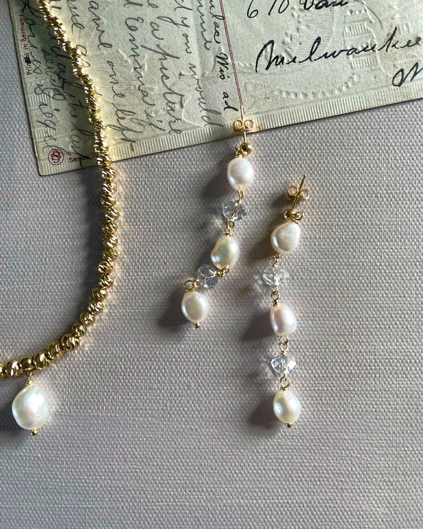 The chandelier earrings in white freshwater pearls